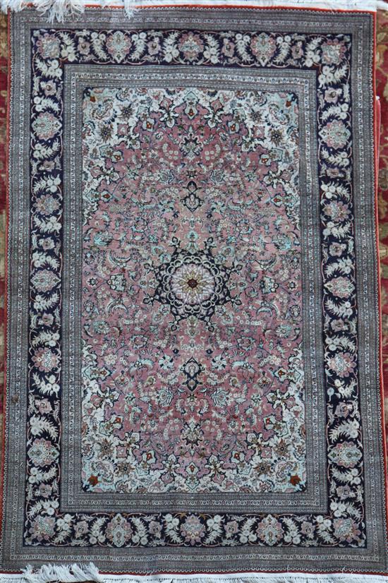A Chinese silk pink ground rug, 6ft by 4ft.